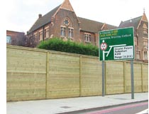 Acoustic barrier fence for blocking highway noise next to road sign
