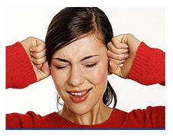 woman covering her ears with hands to ptotect against loud noise