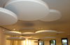 several white cloud 9 circular sound absorber suspended from ceiling