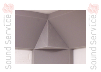 close-up of grey foam sound absorbing corner cube fitted with triangular absorbers