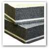 corner view of two sheets of black soundproofing foam