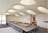 white circular cloudsorption shapes suspended from ceiling of an office