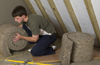 man installing Thermafleece into loft