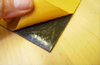 release paper being peeled from Dedsheet vibration damping sheet