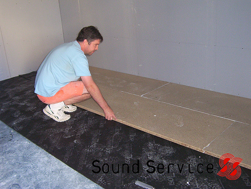 man installing floating floor using R10 and quietboard