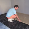 man installating QuietBoard high density acoustic flooring